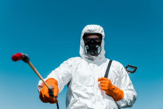 An ant exterminator preparing to spray