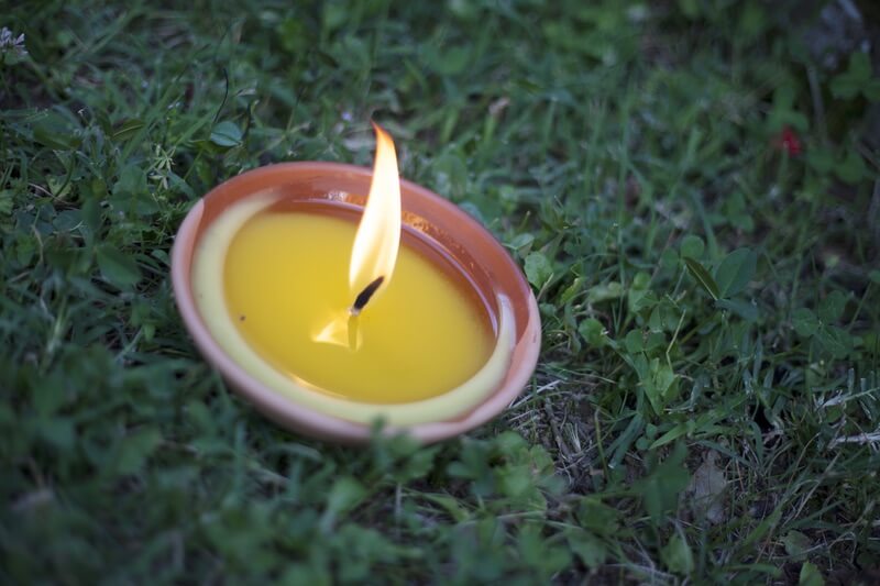 A citronella candle being used to keep flies away